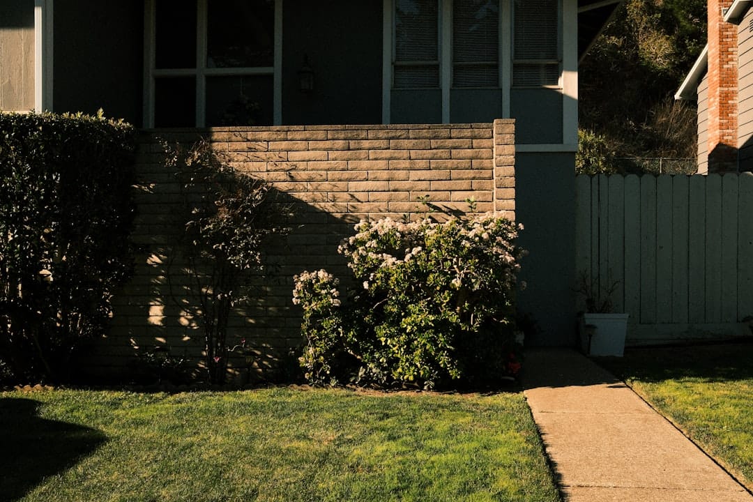 A suburban house with a walkway and green lawn.